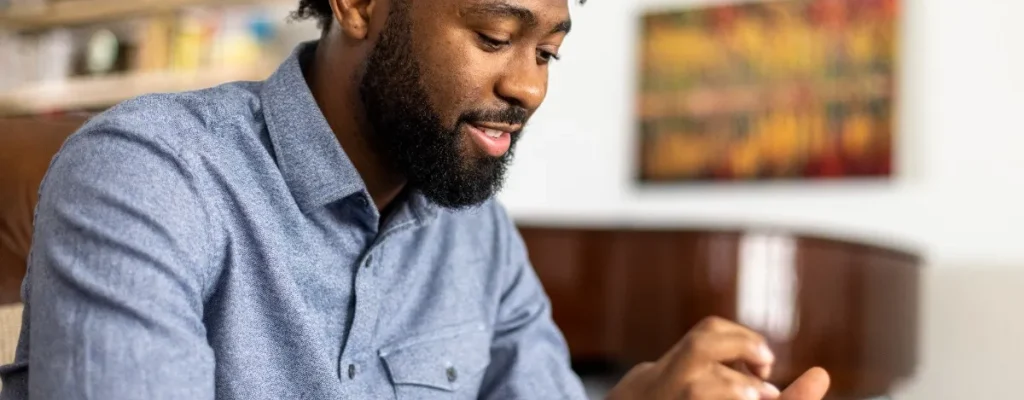 homem sentado mexendo no celular